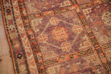 Detail of a distressed Khotan's geometric panels in pale aubergine and faded tomato red.