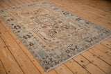 Distressed vintage Hamadan rug, meandering vine border with slate blue, sand, brown patterns.
