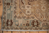 Corner of distressed Hamadan rug with intact slate blue selvage, fringe, and meandering vine floral border.