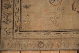 Low-pile texture and charcoal border details on a distressed antique Karabagh rug corner.