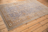 Distressed Sivas rug corner, dusty blue field, coffee brown Turtle Samovar border detail.