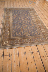 Distressed Sivas rug bottom edge with coffee brown Turtle Samovar border, dusty blue field, and heavy abrashes.
