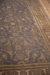 Distressed Sivas rug, dusty blue field with Herati vines, and brown Turtle Samovar border.