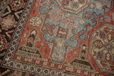 Detailed view of the crab style and wave motif borders on an antique Caucasian Soumac.