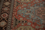 Angled view of an antique Soumac's flat weave, showing a crab-style border in brick red and dusty blue.