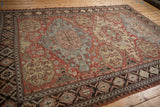 Antique Caucasian Soumac carpet from an angled perspective, showing its triple medallions and intricate borders.