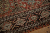 Detail of the antique Soumac's crab-style border in charcoal, madder red, and dusty blue.