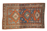Antique hand-knotted Caucasian Kazak rug, triple geometric medallions in madder red and sapphire blue, 4'6