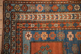 Antique Kazak rug corner, rich geometric borders with hook and latch motifs: madder, sapphire, mallard.