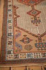 Geometric pawn design border and low-pile texture of a vintage hand-knotted Serab runner.