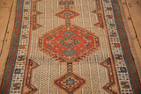Angled view of the vintage Serab runner's medallion, intricate vine ground, and pawn motif border.
