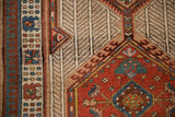 Reciprocating pawn design motif border next to the intricate medallion of a vintage Serab rug.