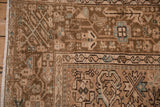 Geometric boteh border and worn, hand-knotted pile on a vintage Persian Karaja rug corner.