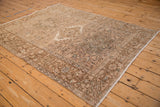 Angled view of the full vintage Karaja rug highlighting its geometric design and distressed, earthy tones.