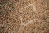 Close-up of the distressed Karaja rug's low pile, showing geometric motifs and knot heads.