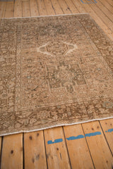 Angled perspective of a vintage Karaja rug's geometric medallion and distressed pile.
