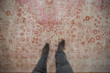 Distressed vintage Kaisary rug, softened fuchsia and terra cotta thousand flower design.