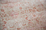 Vintage Distressed Kaisary carpet detail: Time-softened tones of fuchsia and terracotta thousand flower design.