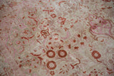 Distressed vintage Kaisary carpet showcasing faded fuchsia, terra cotta, and ivory thousand flower patterns with even pile wear.
