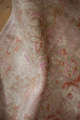 Textured pile of vintage distressed Kaisary carpet in fuchsia, terra cotta, and ivory.