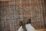 Overhead view of vintage Hamadan runner's distressed Herati design in soft blue and rust tones.
