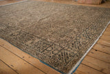 Distressed Karaja rug corner: geometric patterns, worn pile, olive border, intact selvage.
