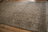 Distressed vintage Karaja carpet showing side selvage, patterned border, and even knot head wear.