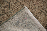 Distressed Karaja rug pile detail, showing geometric design, hand-knotted foundation, and green selvage.