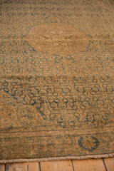 Distressed vintage Bijar rug pile detail, showing mostly even wear and muted teal motifs.