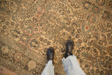 A top-down view showing the scale and worn floral texture of a vintage Lilihan carpet.
