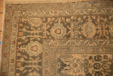 Corner detail of a distressed Lilihan carpet showing the floral borders and mostly even wear.