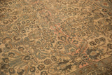 Textured, low pile of a distressed Persian Lilihan carpet showing floral bouquets and sprawling vines.