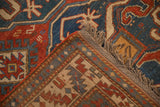 The sturdy side cord selvage and hand-knotted pile of an antique Kazak rug seen at a folded corner.