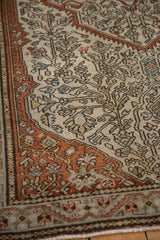 The even wear and visible knot heads of an antique Malayer rug with intricate floral vine motifs.