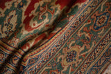 The hand-knotted pile of a vintage Mahal carpet showing the turtle samovar border in red, jade, and blue.