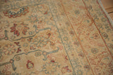 Geometric bird motifs and floral arabesques on the low, worn pile of a Persian Tabriz.