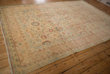 Low-angle view of the distressed Persian Tabriz carpet highlighting its faded palette and evenly worn texture.