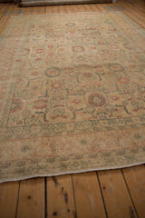 Surface-level view of a vintage Tabriz carpet highlighting the even wear across its floral field.