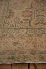 Detail of the worn, low pile on a vintage Tabriz showing its faint foundation and floral border.
