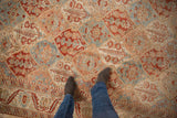 Detailed view of the distressed, low-pile texture in a Persian Bakhtiari rug's lattice pattern.