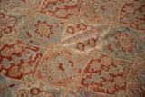 Close-up on the vintage Bakhtiari carpet's low pile, showing mostly even wear across the knot heads.