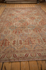 A perspective view down the distressed field of a Bakhtiari carpet's cypress tree lattice.