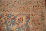 Even wear across the knot heads on the slate blue and raspberry corner spandrel of a Tabriz carpet.