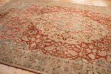 Low angle view over the corner of a distressed Tabriz rug, showing the worn texture of its floral field and border.