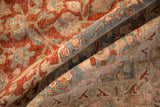 Close view of a vintage Tabriz carpet's low pile, highlighting the even wear of its floral pattern.