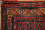 Corner detail of a vintage Malayer showing the boteh spandrel and serrated leaf border.