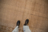 A close-up view showing the short pile texture and allover seed design of a distressed Kars carpet.