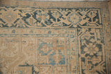 Heriz carpet corner with detailed double vine Turtle Samovar border and cream, dusty blue hues.
