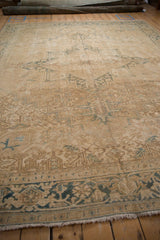 Distressed vintage Heriz rug border detail with cream, sand, dusty blue Herati pattern.