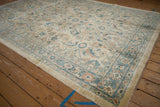 Angled view of the Mahal carpet showing the Herati pattern and dusty teal border.